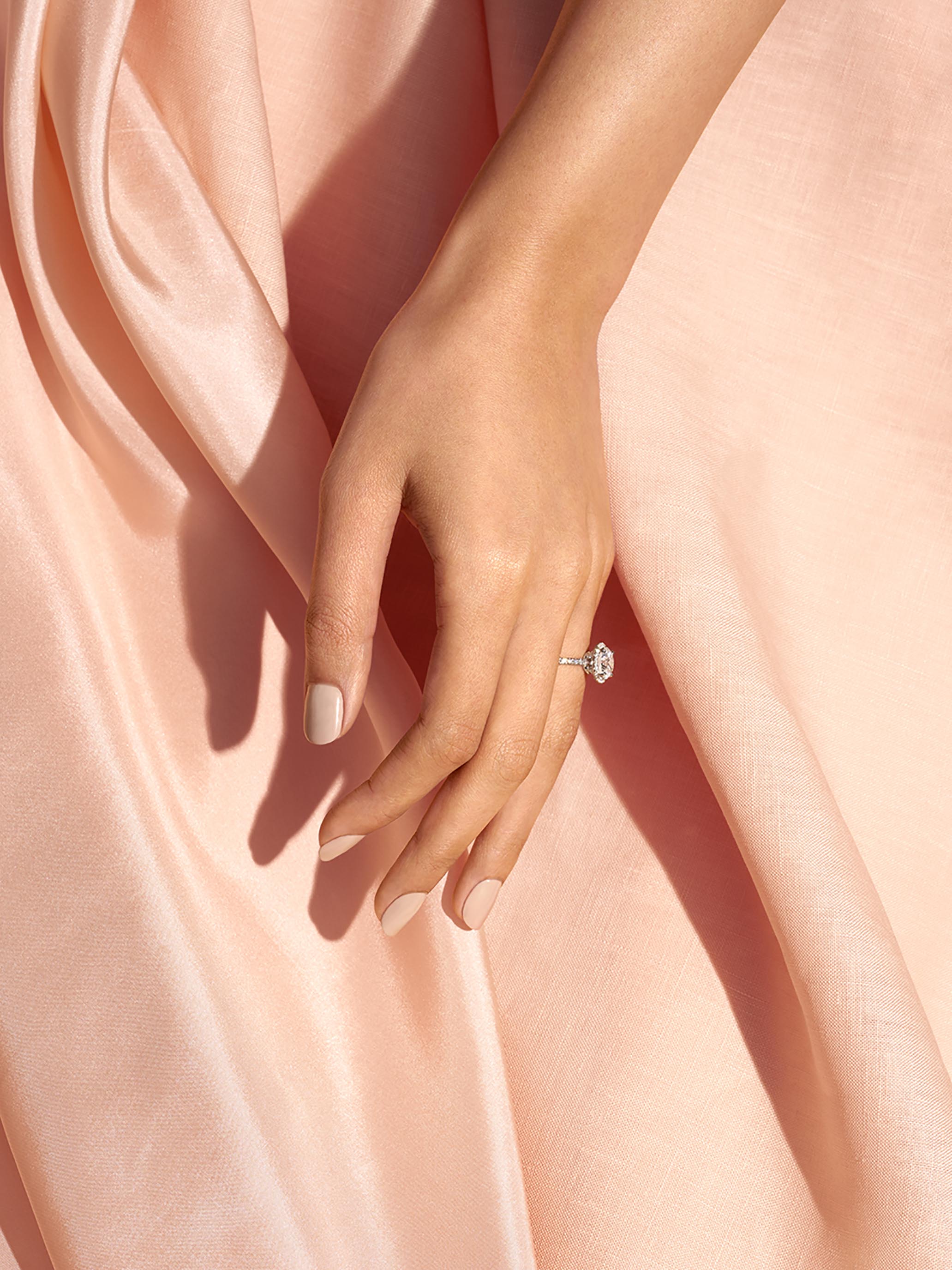 STAN Couple Engagement Rings Halo Diamond on Caucasian Skin Hand